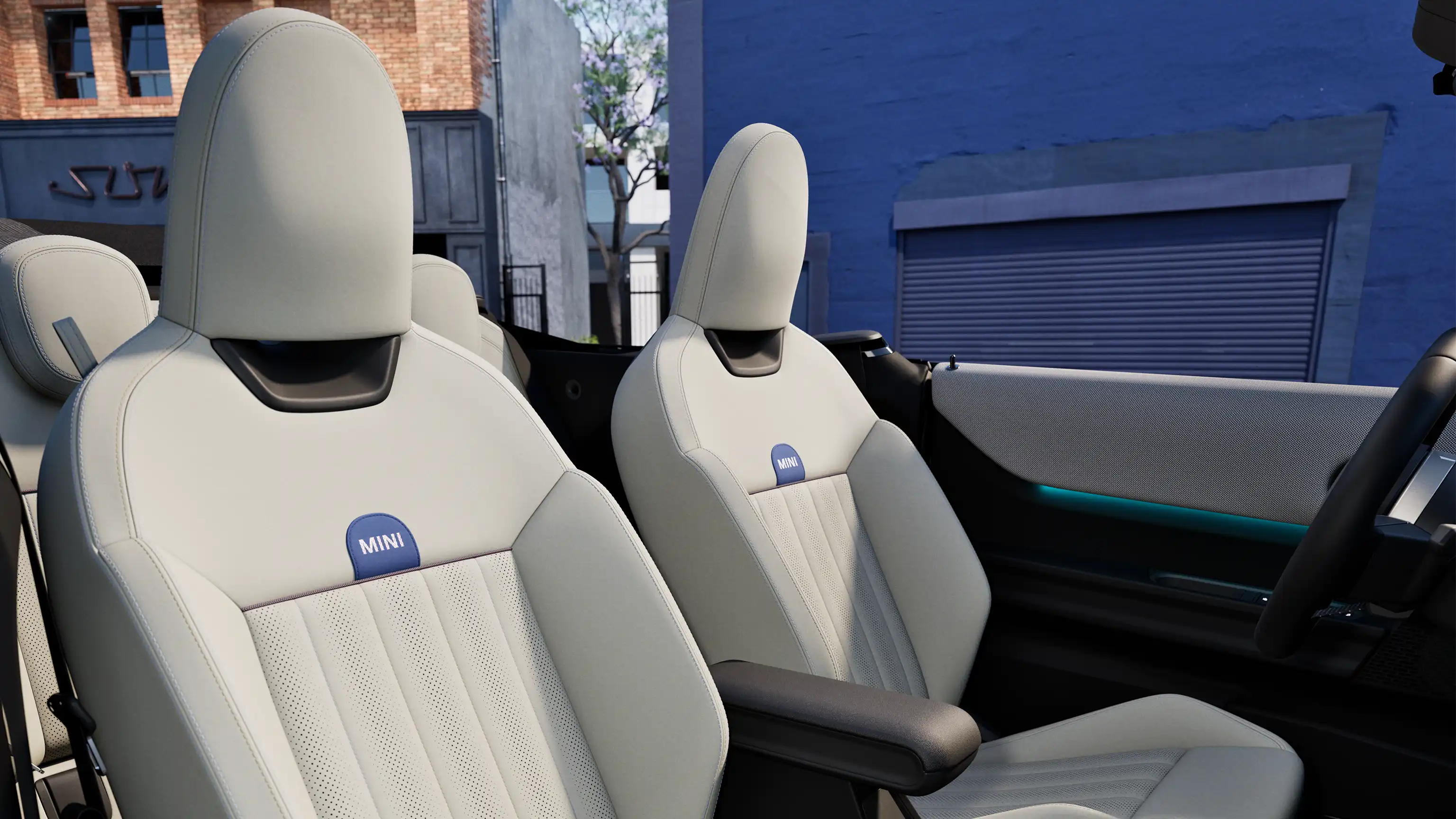 Interior perspective of the MINI Cooper Convertible is showing the dashboard, steering wheel, round display and back of the frontseats.